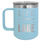 Laser etched light blue 15 oz vacuum insulated coffee mug with 'Life is Better at the Lake' design