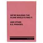 Large pink leatherette sketch book laser etched with 'We're Building The Plane While Flying It. And Other B.S. Phrases' design