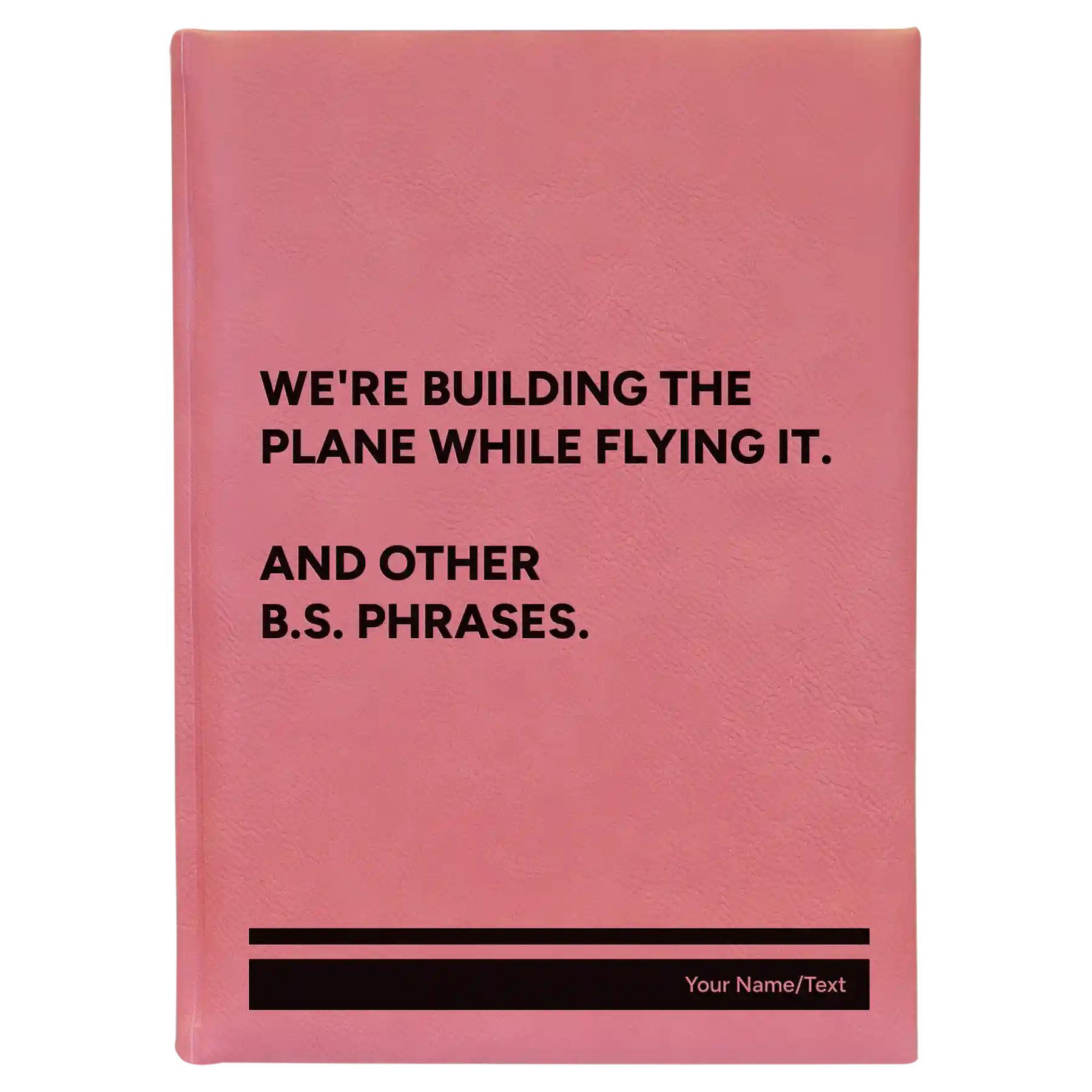 Large pink leatherette sketch book laser etched with 'We're Building The Plane While Flying It. And Other B.S. Phrases' design