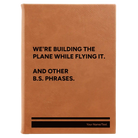 Large rawhide leatherette sketch book laser etched with 'We're Building The Plane While Flying It. And Other B.S. Phrases' design