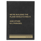 Large black/gold leatherette journal laser etched with 'We're Building The Plane While Flying It. And Other B.S. Phrases' design