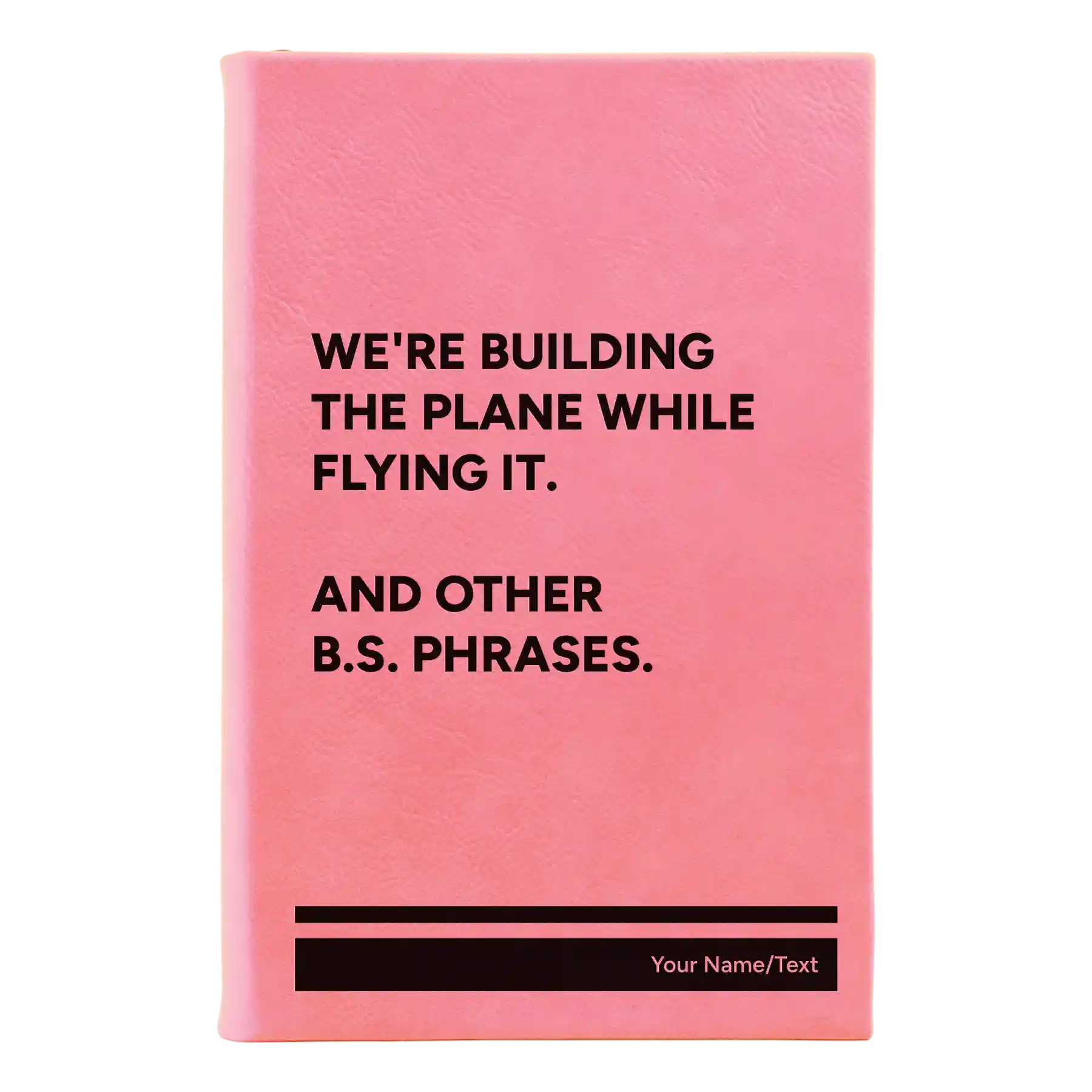 Small pink leatherette journal laser etched with 'We're Building The Plane While Flying It. And Other B.S. Phrases' design