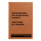 Small rawhide leatherette journal laser etched with 'We're Building The Plane While Flying It. And Other B.S. Phrases' design