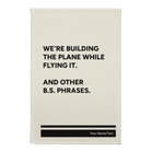 Small white leatherette journal laser etched with 'We're Building The Plane While Flying It. And Other B.S. Phrases' design