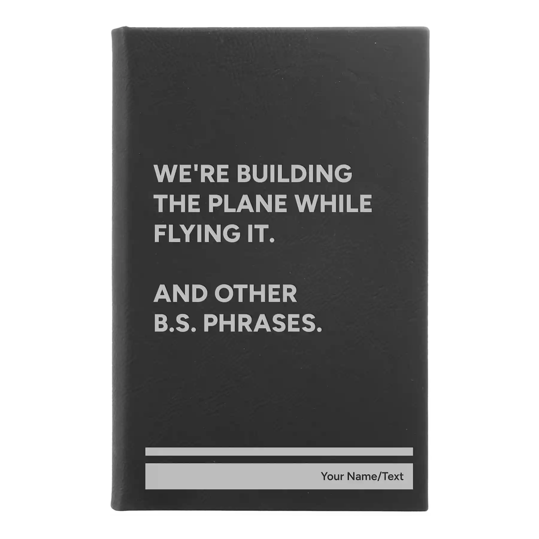 Small black/silver leatherette journal laser etched with 'We're Building The Plane While Flying It. And Other B.S. Phrases' design