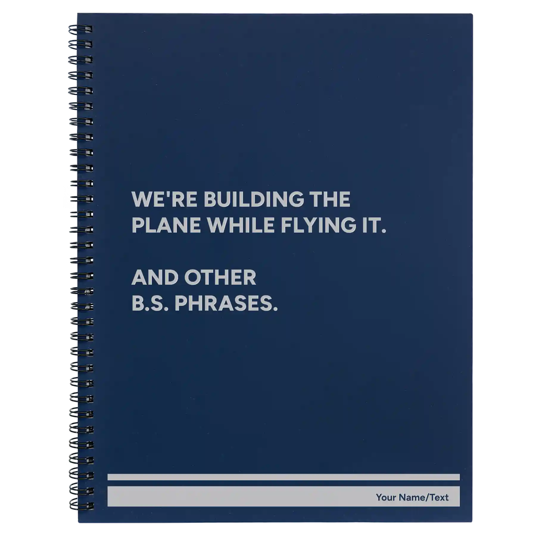 Large blue spiral notebook laser etched with 'We're Building The Plane While Flying It. And Other B.S. Phrases' design