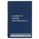 Small blue spiral notebook laser etched with 'A guide to caring strategically' design