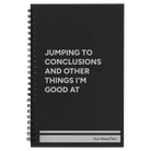 Small black spiral notebook laser etched with 'Jumping to conclusions and other things Im good at' design