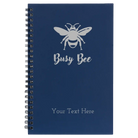 Small blue spiral notebook laser etched with 'Busy Bee' design