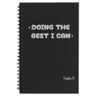 Small black spiral notebook laser etched with 'Doing the Best' design
