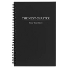 Small black spiral notebook laser etched with 'Next Chapter' design